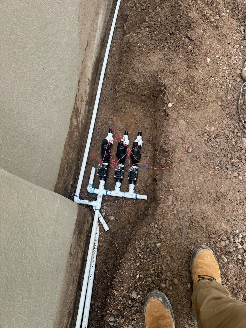 Irrigation valves installed in a trench before backfill